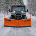 TMG-ATS72 V-shape snow blade mounted on a UTV on a snow-covered road lined with trees.