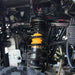 Detailed view of rear suspension and coil spring on ATV