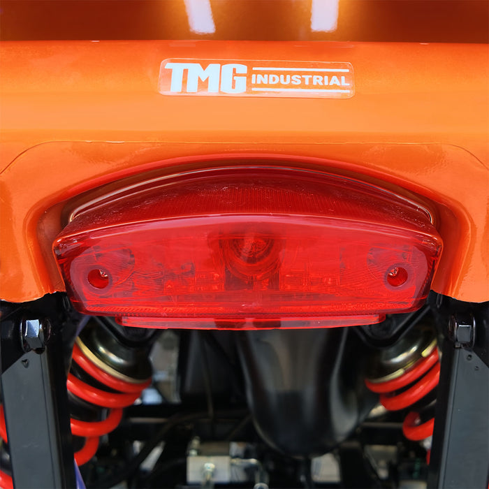 Rear taillight and TMG Industrial logo on orange ATV.