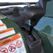 Close-up gear shift lever with warning stickers beside ATV.
