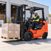 Operator using 2.5 Ton LPG Forklift TMG-FLP25KU to carry pallet outdoors